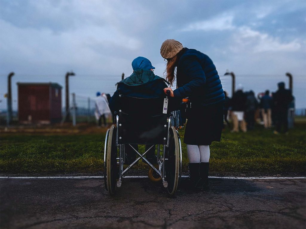 resident in wheelchair with carer